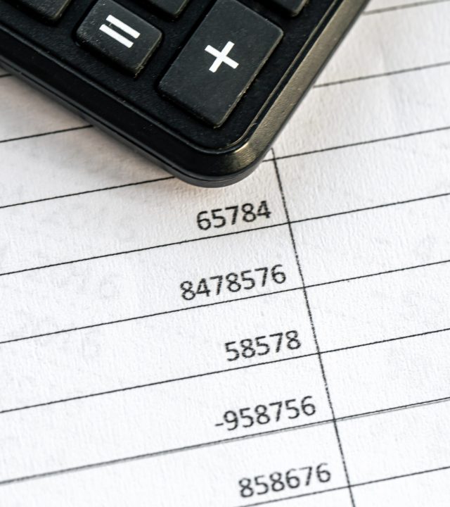 calculator and numbers on paper closeup, finance concept.